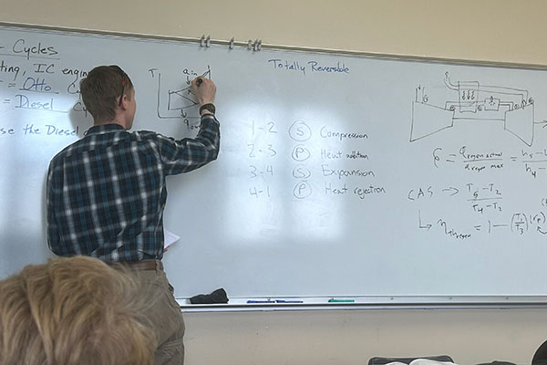 student working at white board