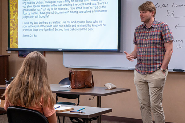 professor teaching at front of classroom