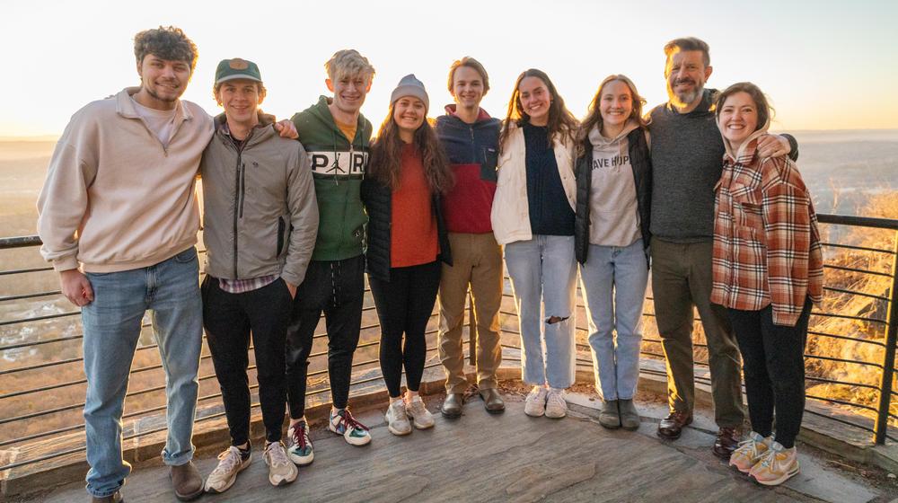 8 student leaders standing with chaplain lowe