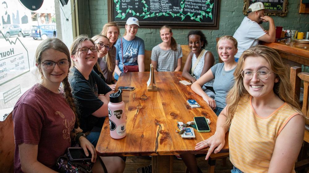 group of female students sitting around a restaurant table