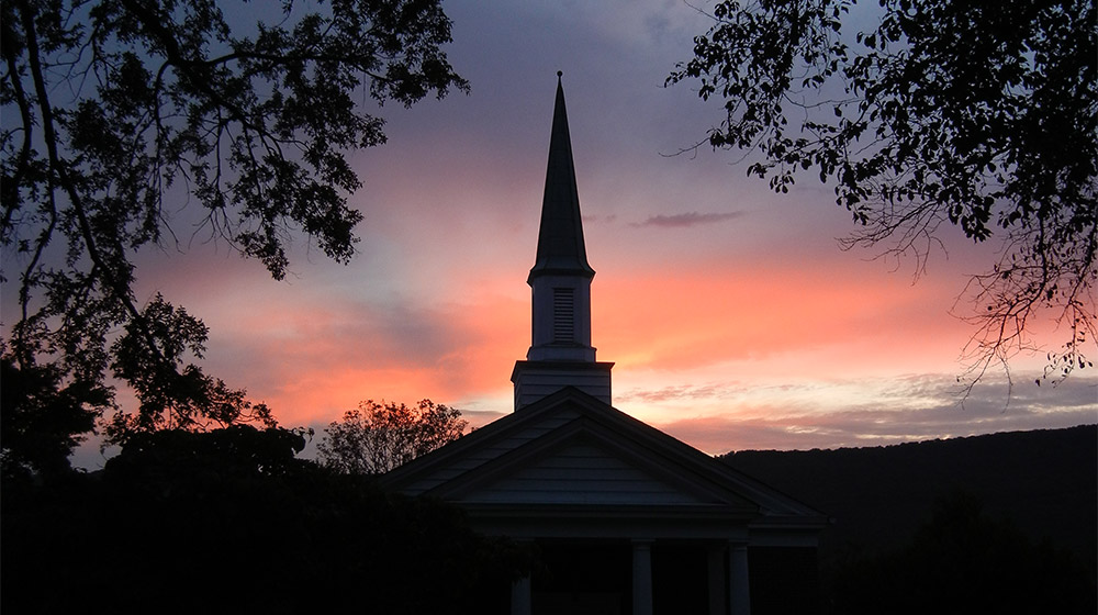 girl smiling and standing outside a local chattanooga church