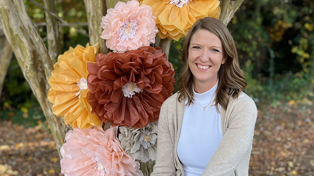 smiling woman with large flowers