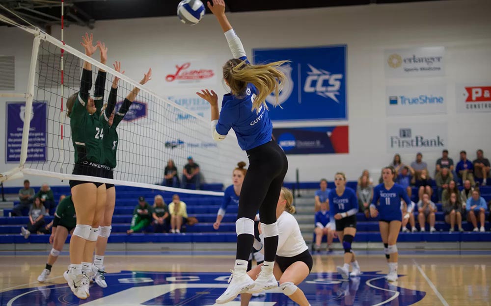 female volleyball player spiking ball