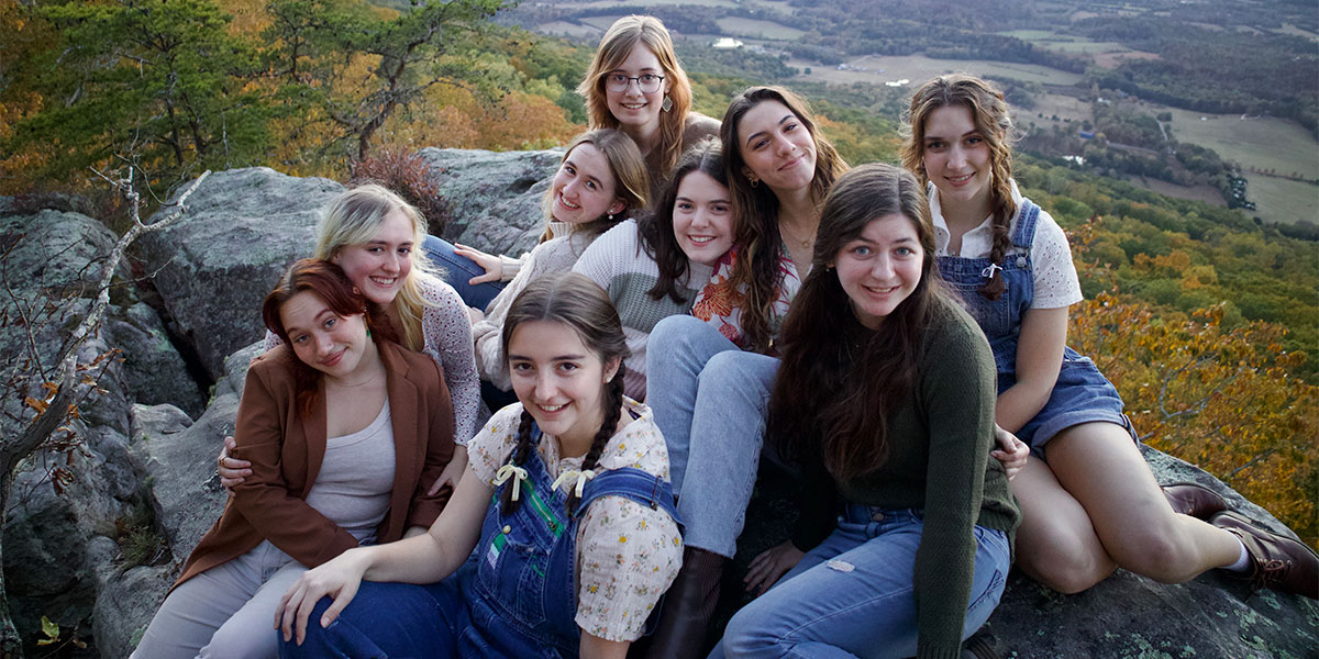 group of females sitting on scenic overlook
