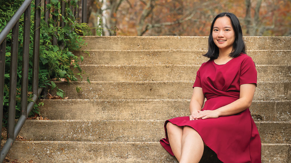 girl in dress sitting on steps