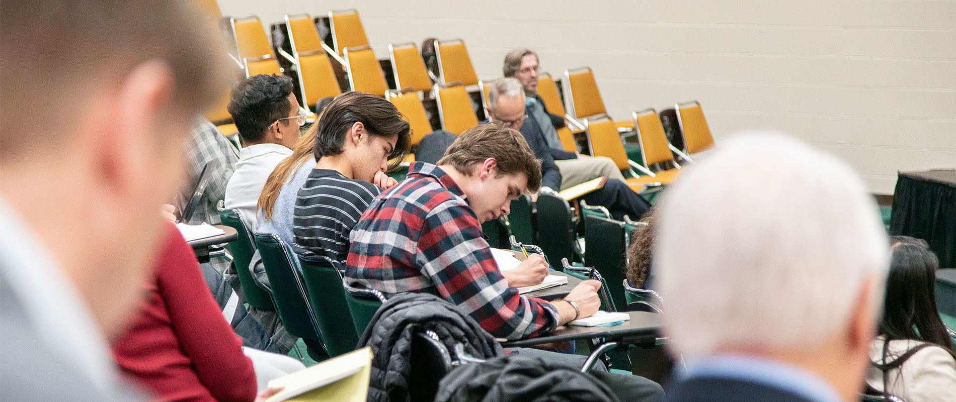 students in lecture hall taking notes
