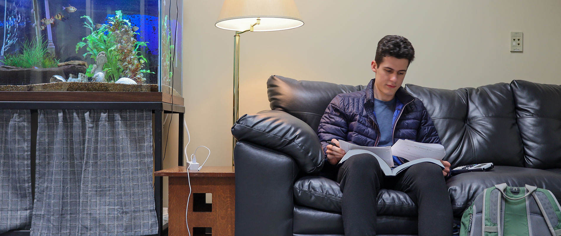 student on couch studying