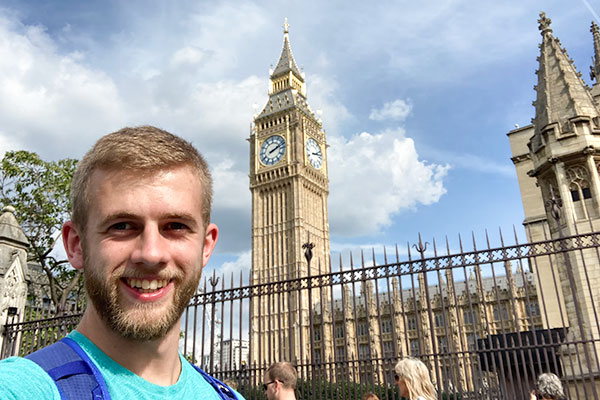 student with clock tower in the background