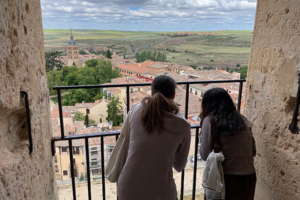 students on balcony overlooking city